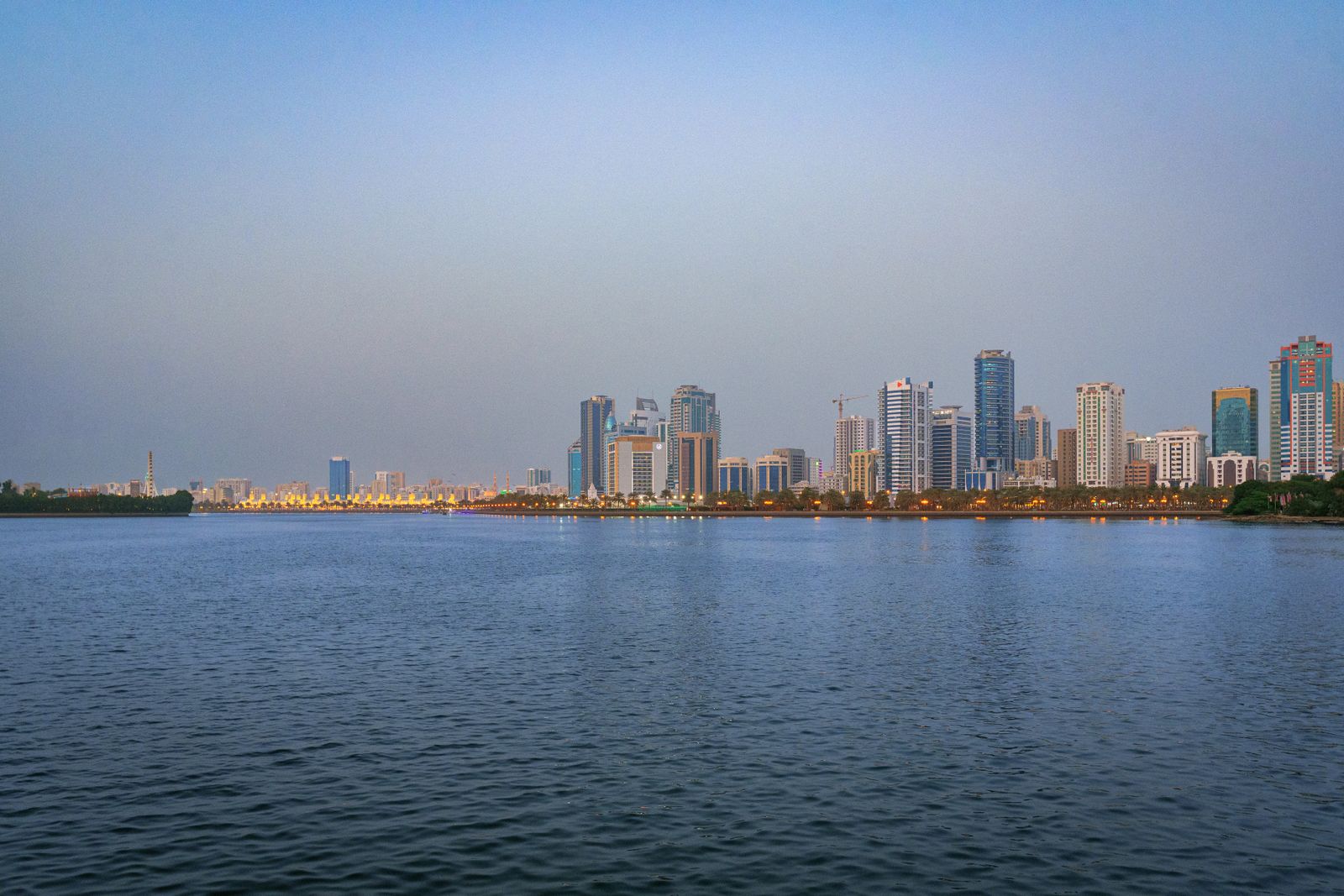 Photo: Siarhei Nester / Pexels The Sharjah skyline reflected on water at dusk