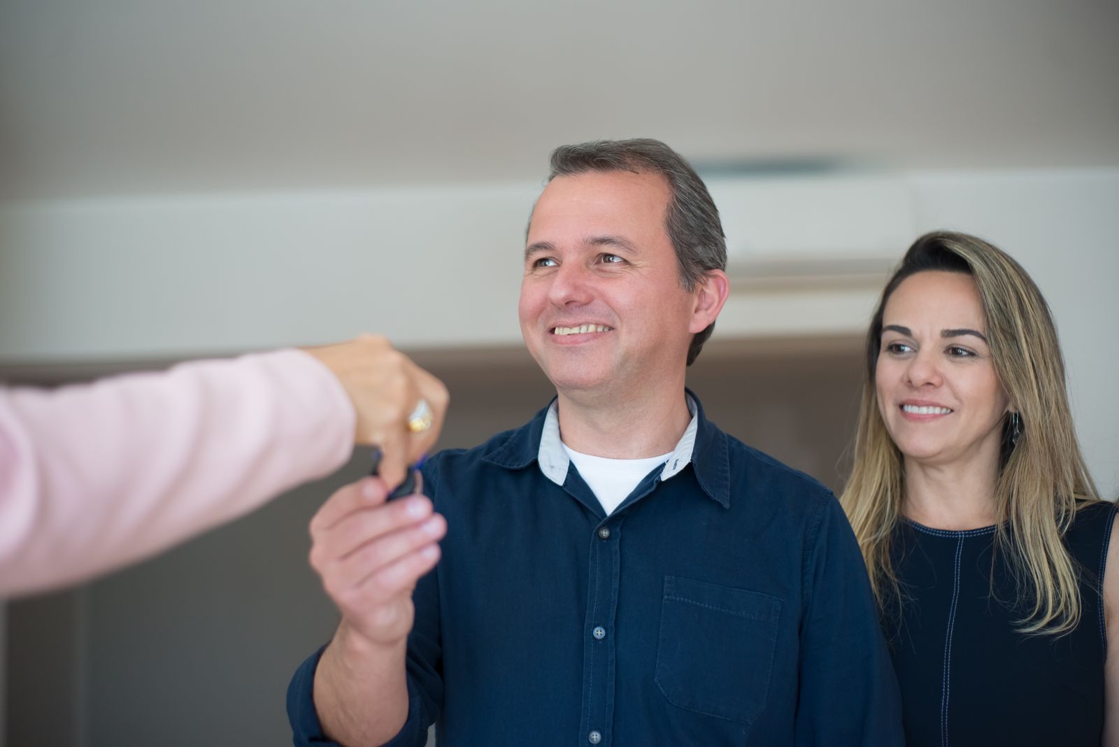 Photo: Kampus Production / Pexels A smiling couple receiving the keys to their new home